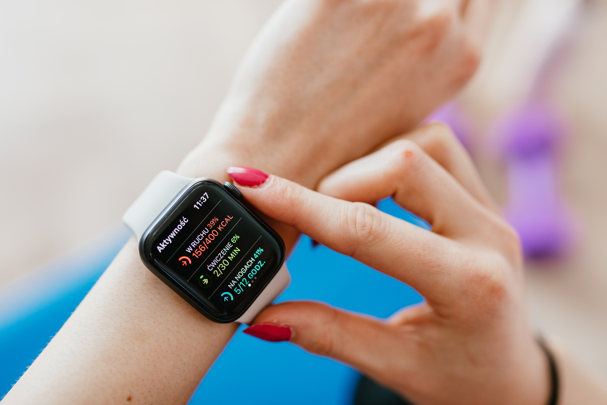 Crop woman checking smartwatch on hand